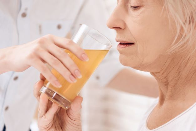 elderly-woman-drinking-juice-hospital